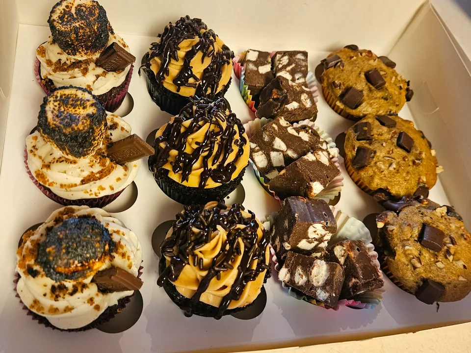 Box filled with assorted decorated cupcakes