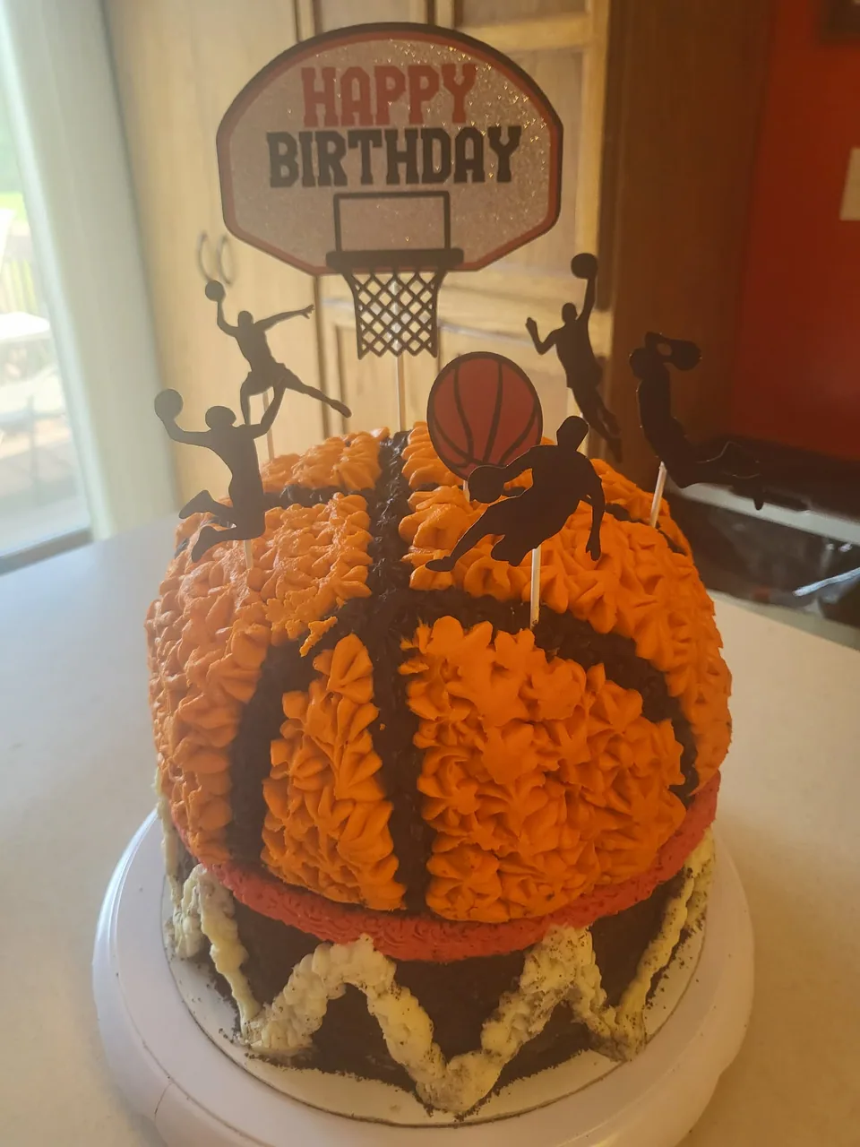 Orange basketball-themed birthday cake with black piping