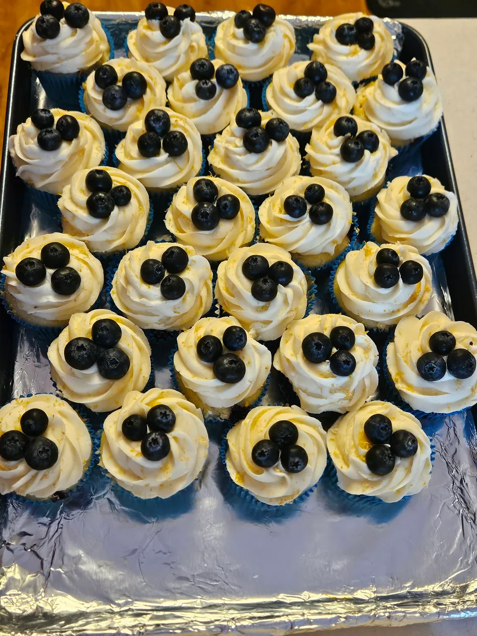 Decorated cupcakes topped with blueberries and chocolate sandwich cookies