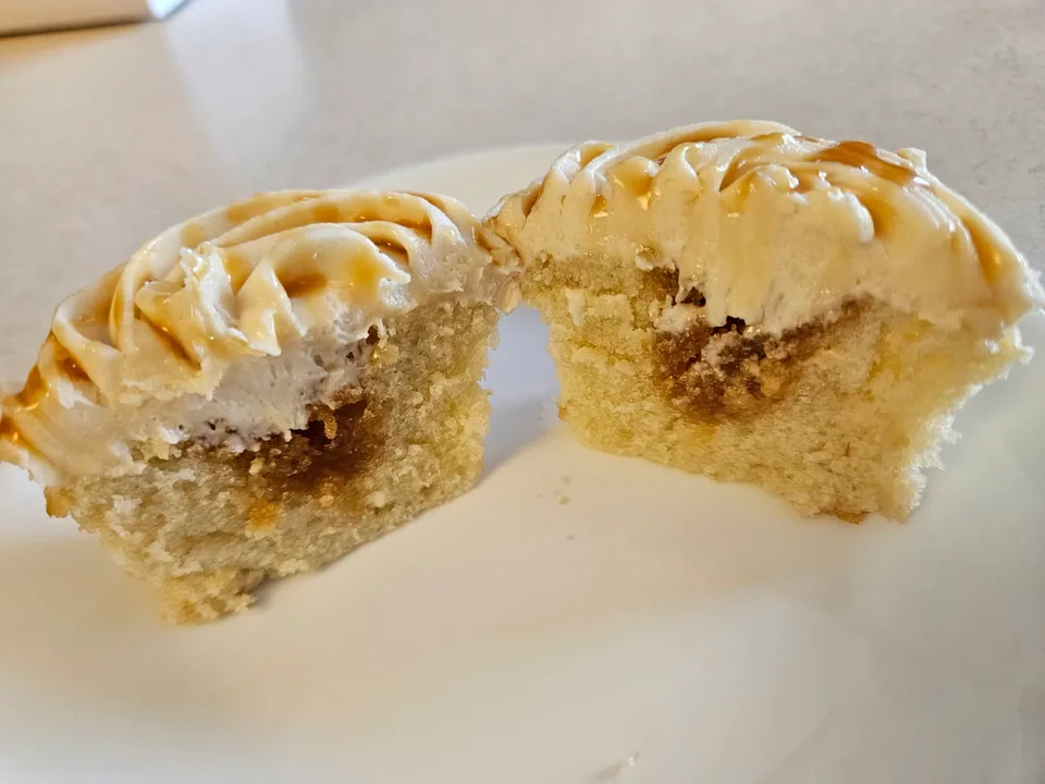 Caramel apple pie cupcake cut open to show its apple filling