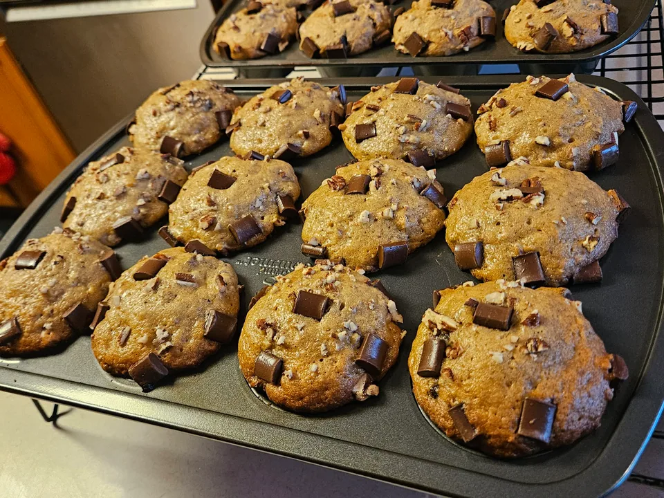 Fresh-baked muffins generously topped with large chocolate chunks