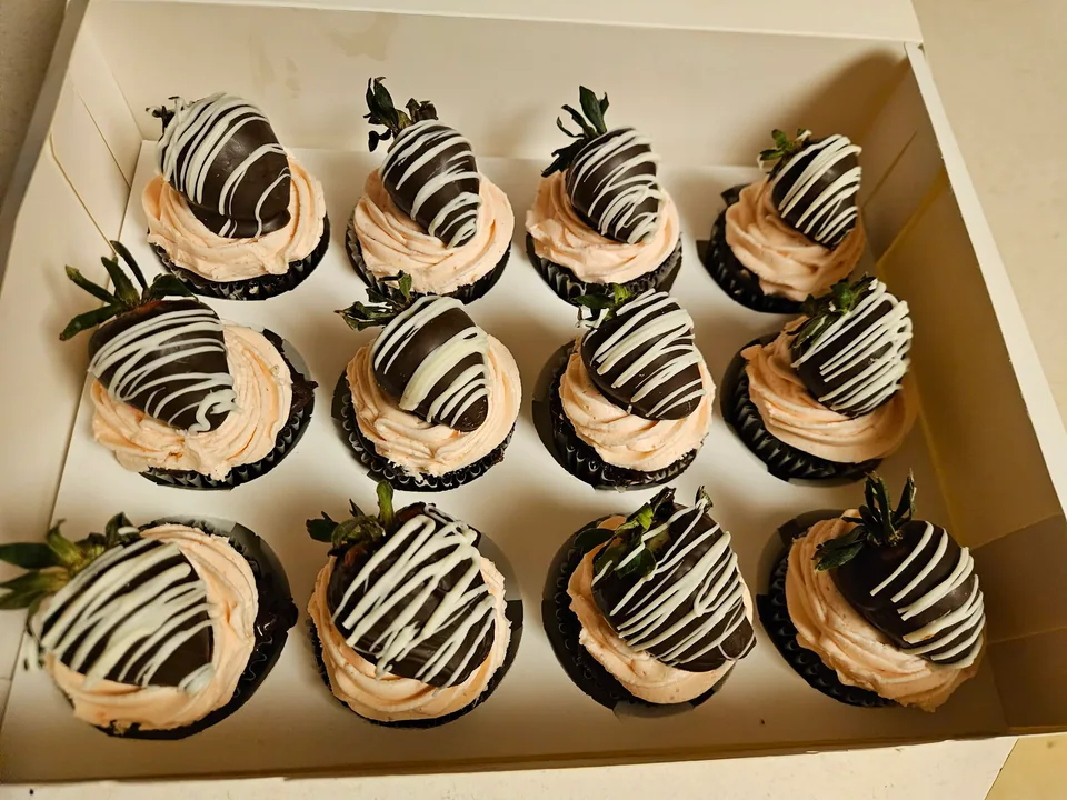 Box of chocolate covered strawberry cupcakes with chocolate drizzle