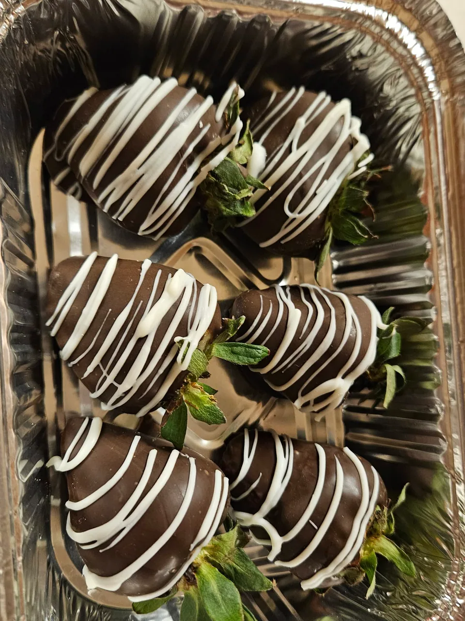 Chocolate covered strawberries decorated with white drizzle