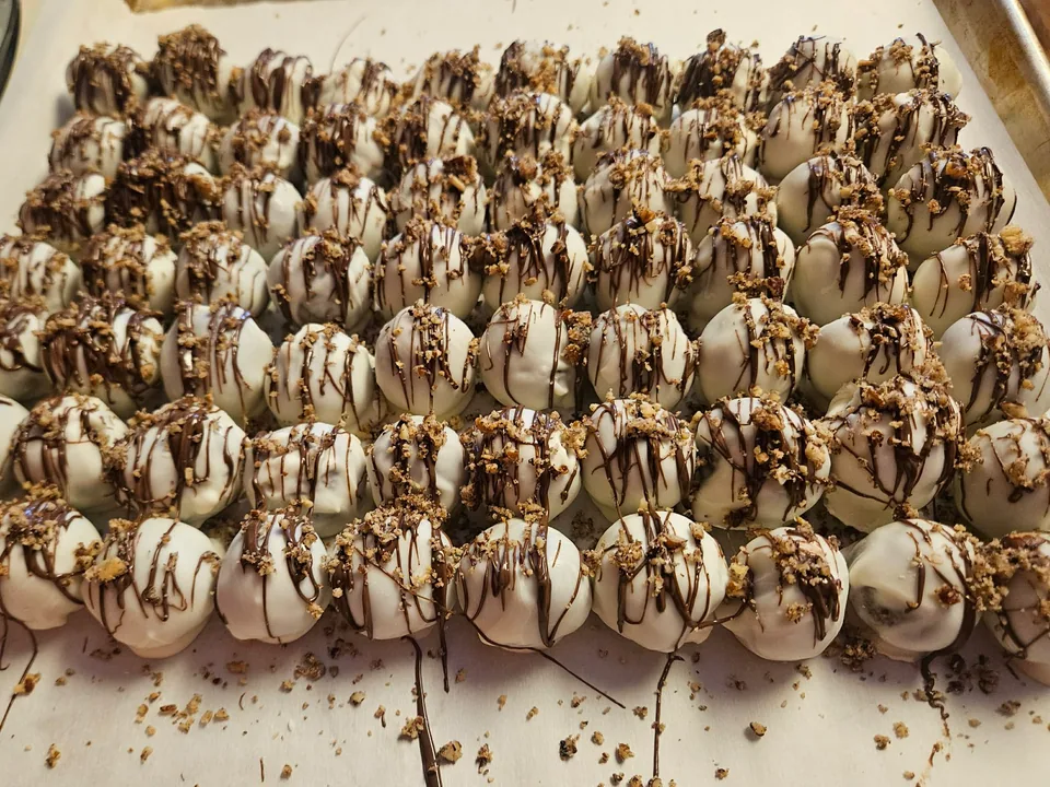 Large assortment of chocolate truffles with contrasting drizzle