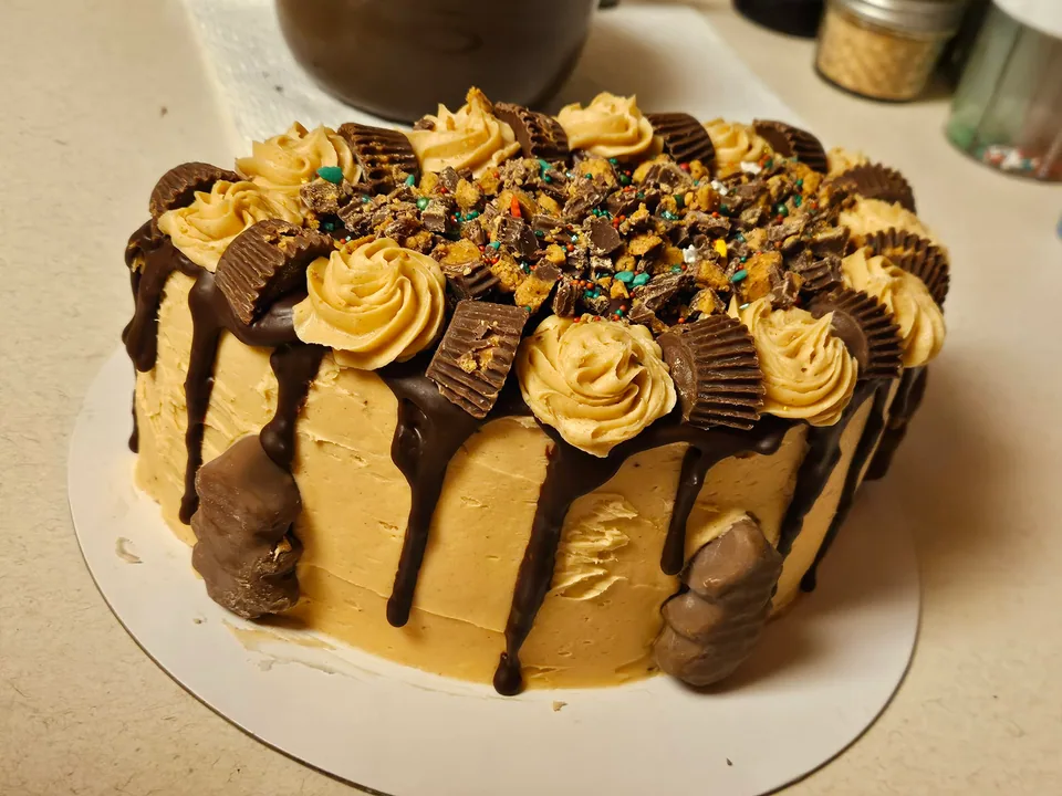 Chocolate peanut butter cake with chocolate drip and peanut butter cups