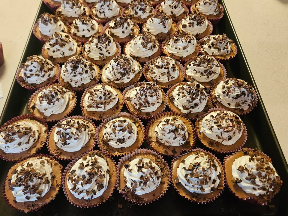 Tray of French silk pies with cream swirls and chocolate shavings