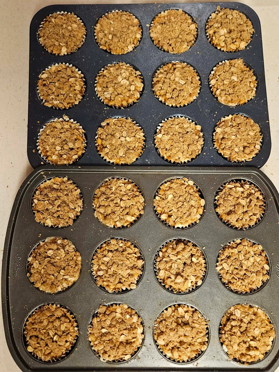 Two pans of scratch-made muffins with crumb topping
