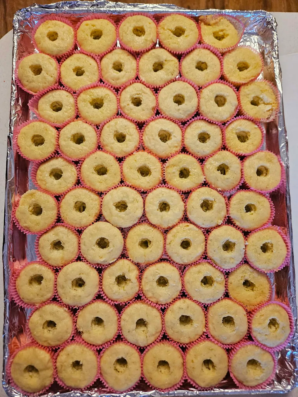 Large tray of mini cupcakes with colorful flower-like piping
