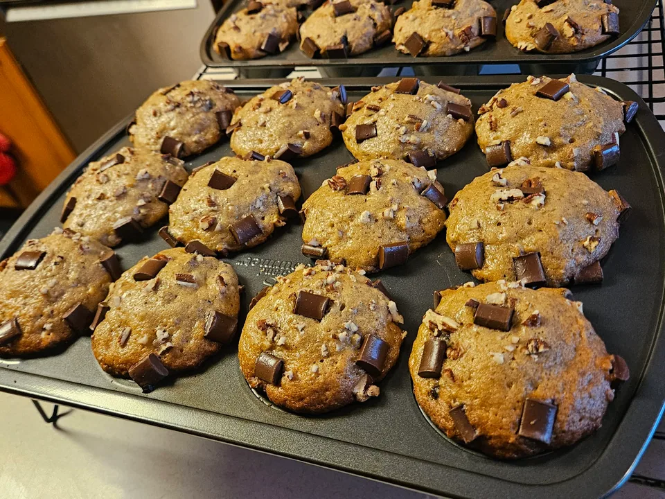 Fresh-baked muffins cooling on wire racks