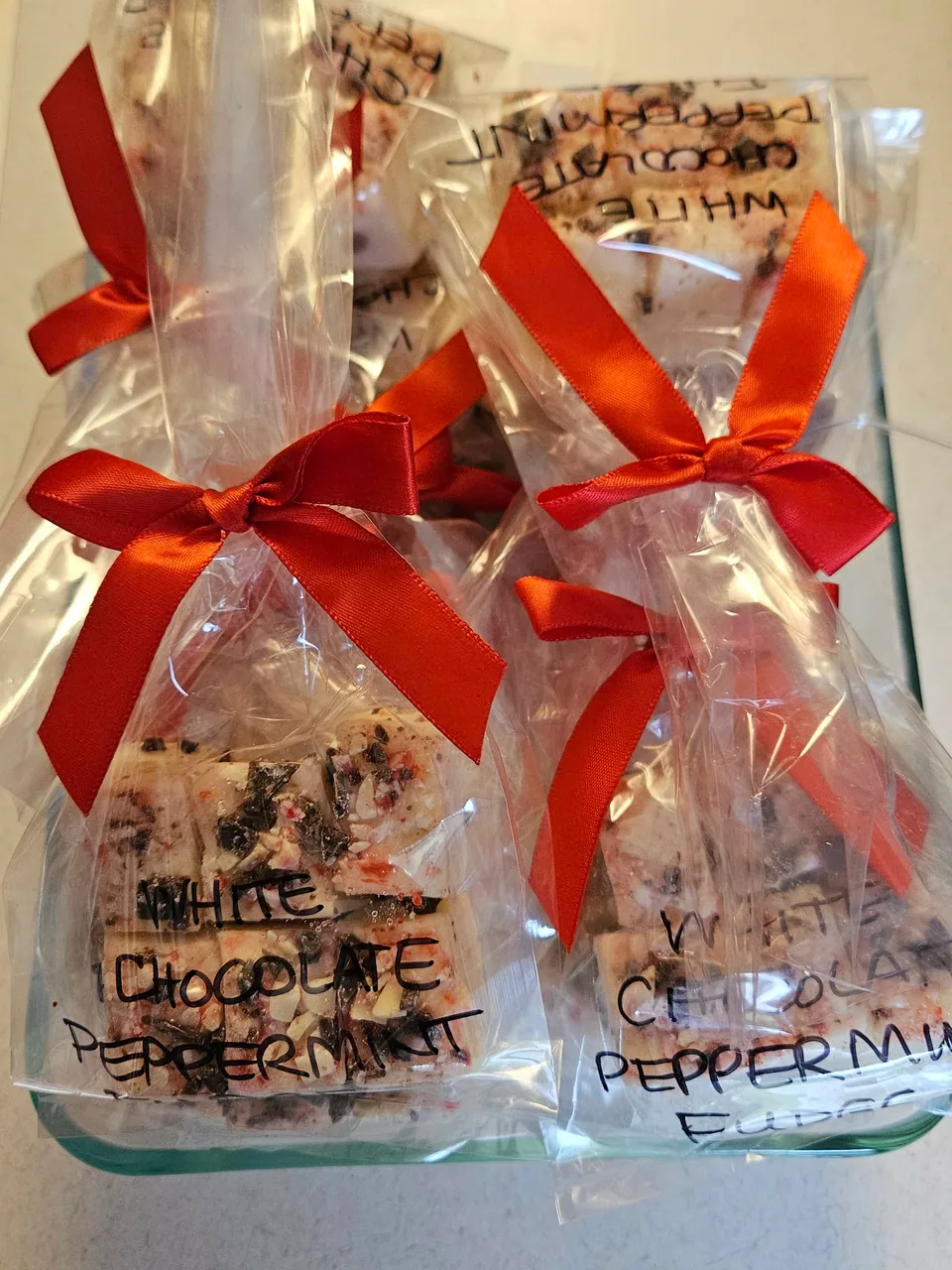 Gift bags of handcrafted fudge tied with red bows