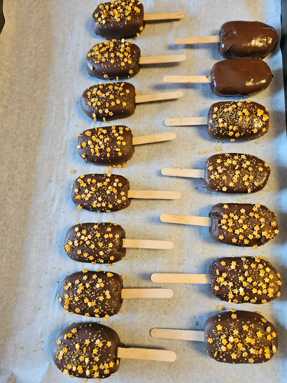 Chocolate-dipped cake pops decorated with gold stars