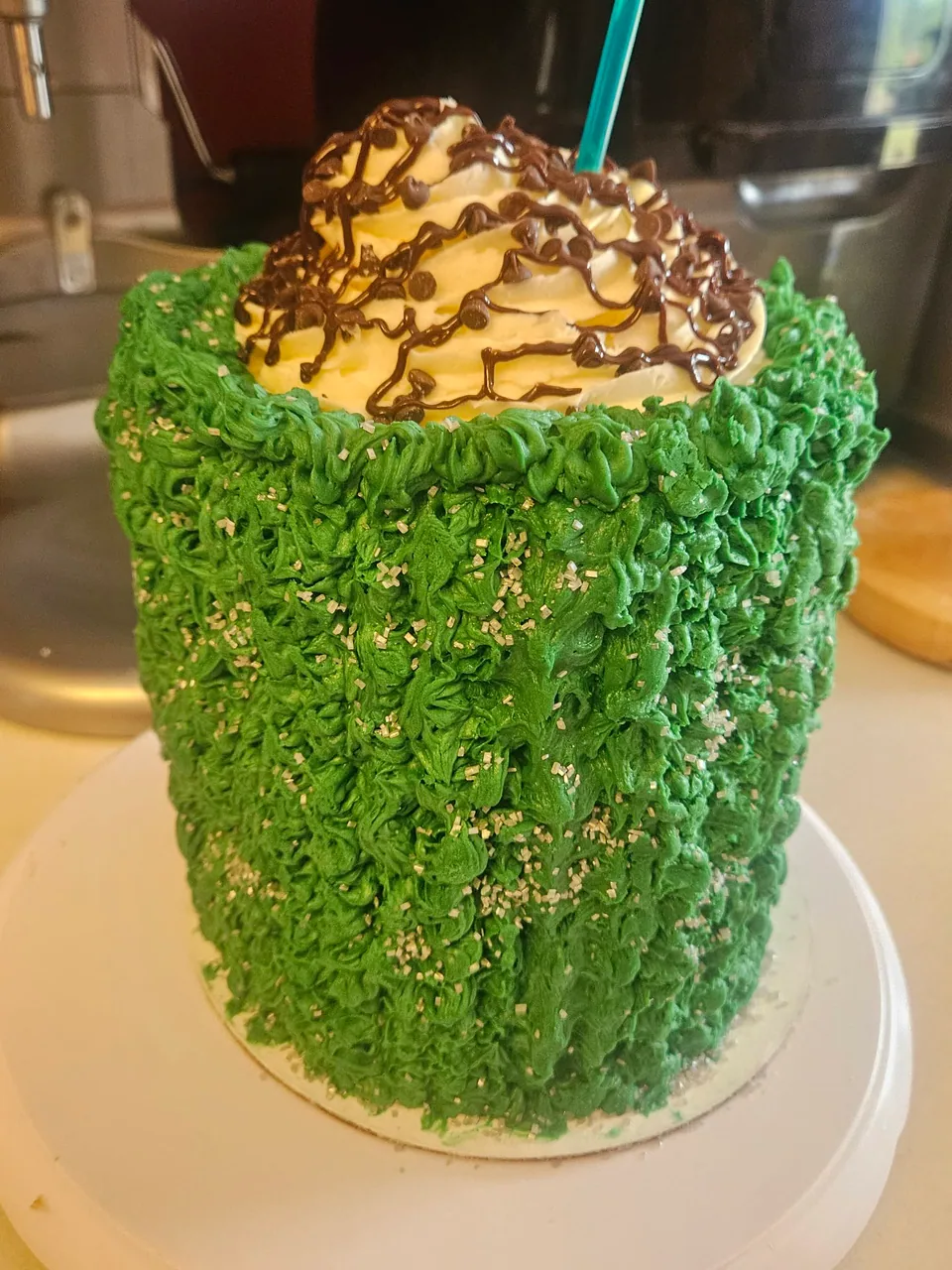 Tall cake covered in textured green piped frosting