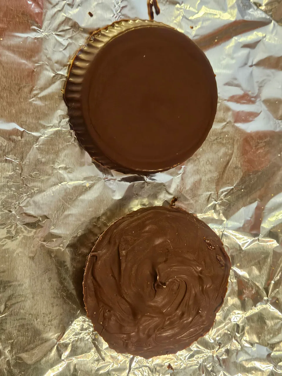 Handmade chocolate peanut butter cups being finished on foil