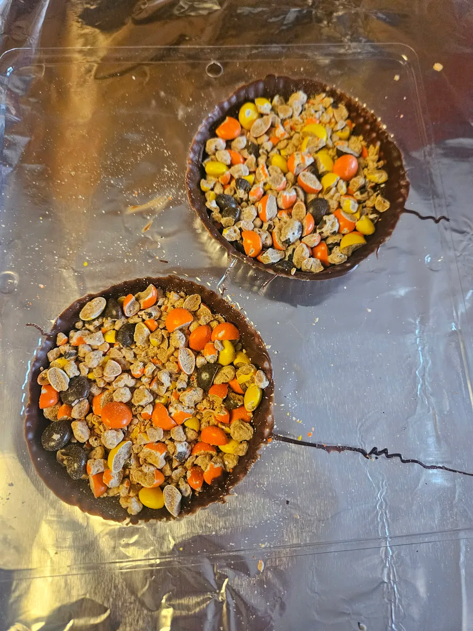 Chocolate shells being filled for handcrafted hot chocolate bombs