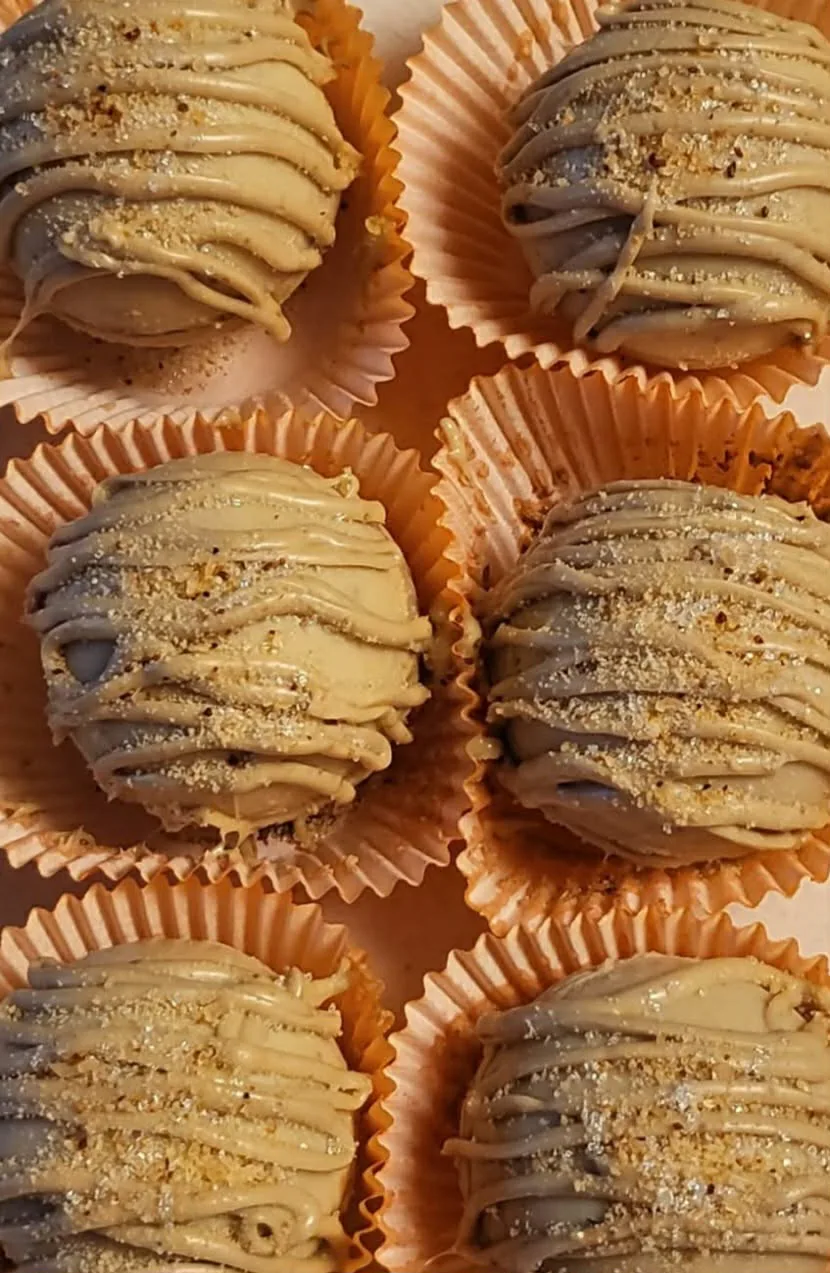 Maple hot chocolate bombs with a light chocolate shell and drizzle