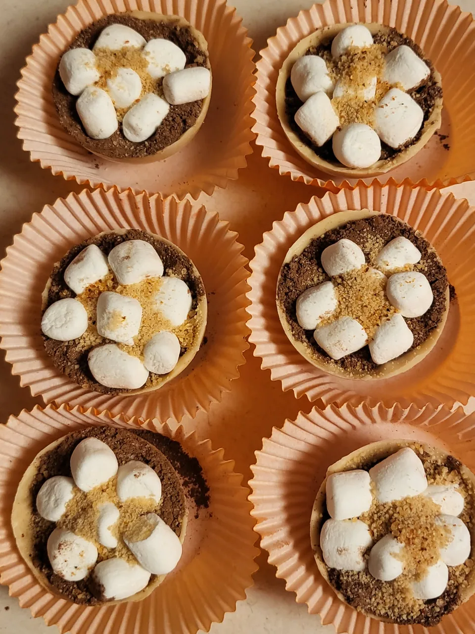 Maple hot chocolate bombs topped with marshmallows and graham crumbs