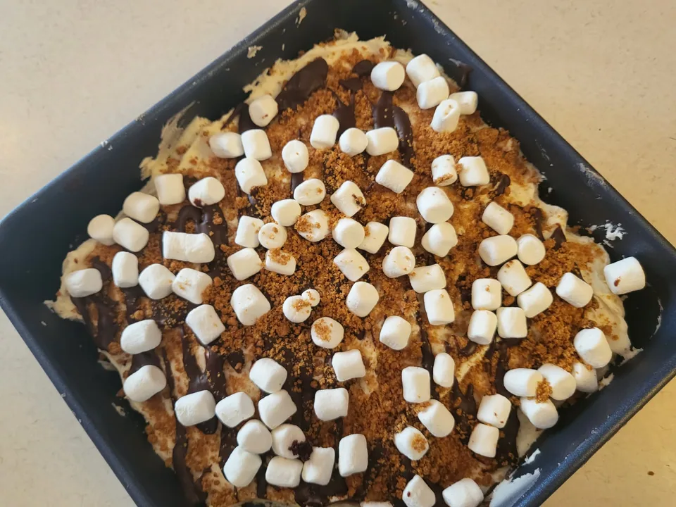 Pan of dessert bars topped with marshmallows and a crumb finish