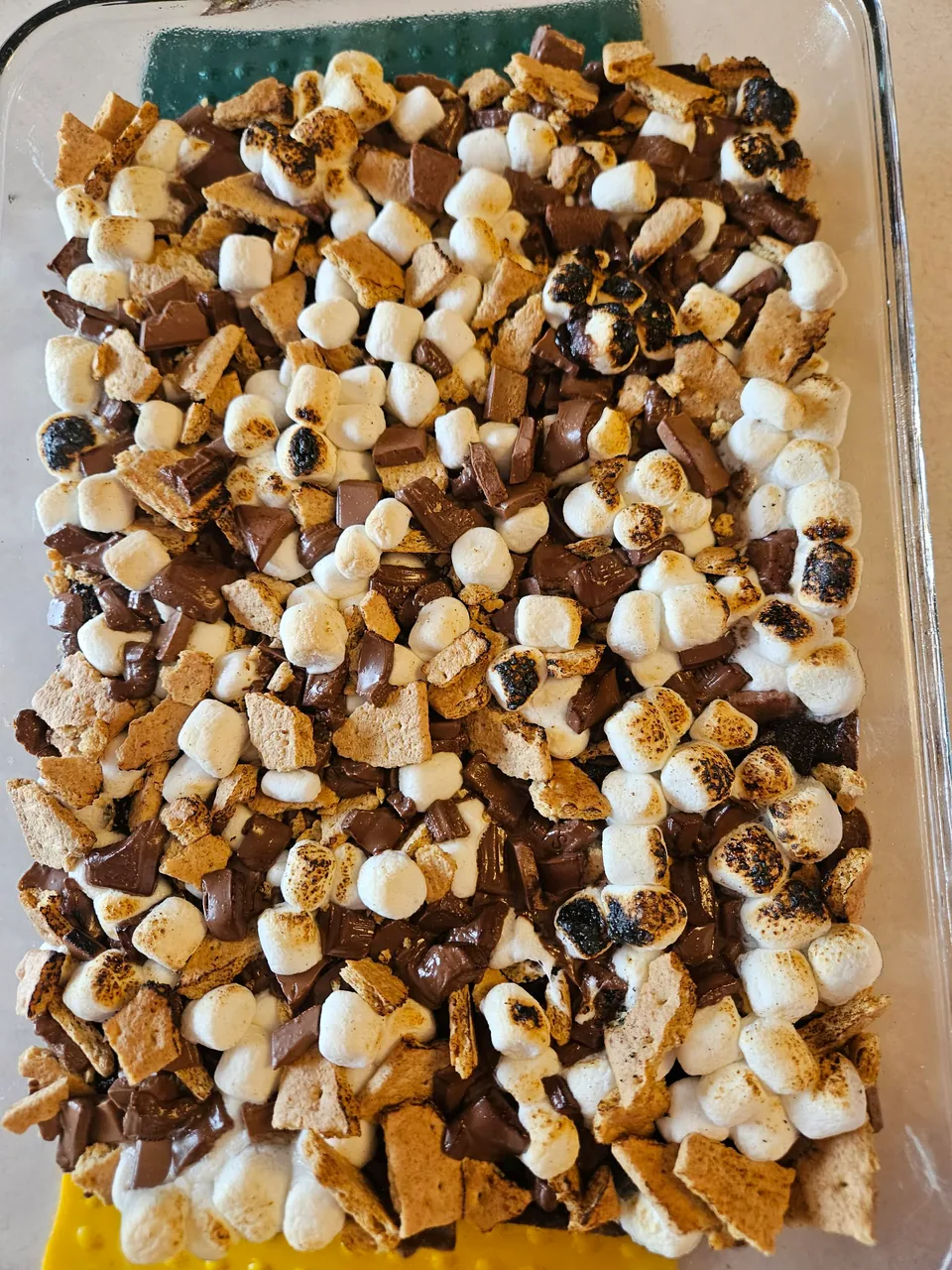 Chocolate brownies generously topped with toasted marshmallows and chocolate pieces