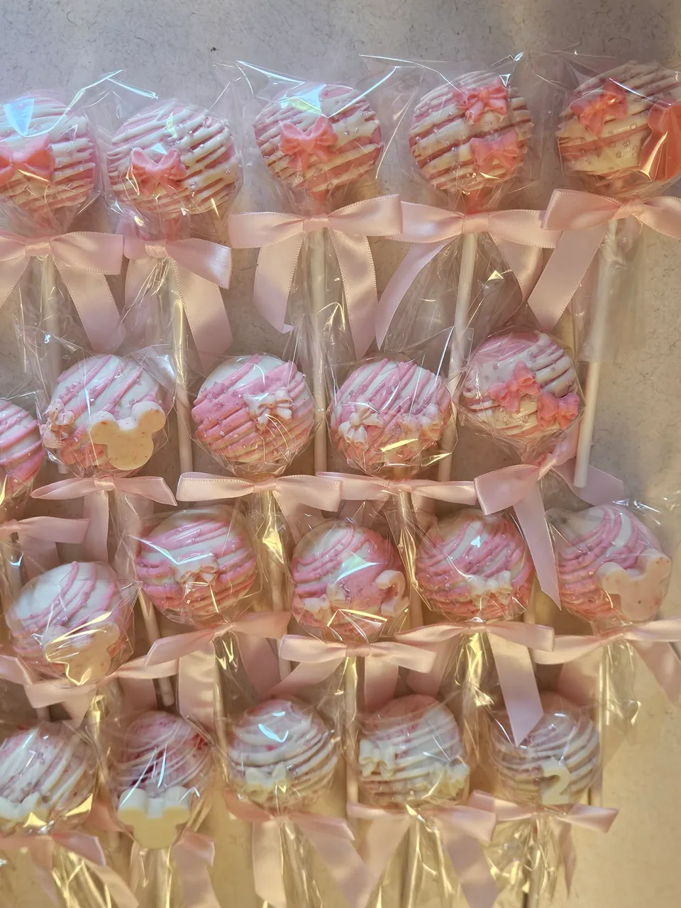 Individually wrapped pink and white decorated cake pops