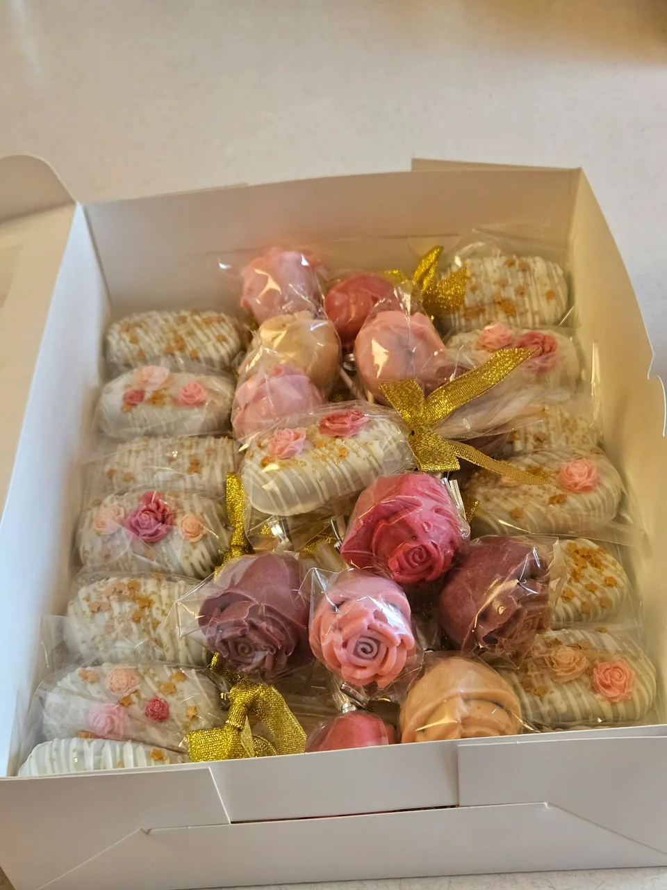 Pink and white hand-dipped treats in a gift box