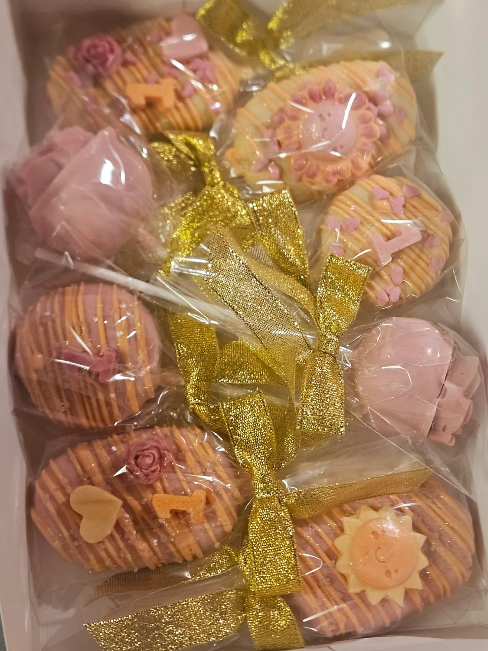 Box of pink and gold decorated cake pops