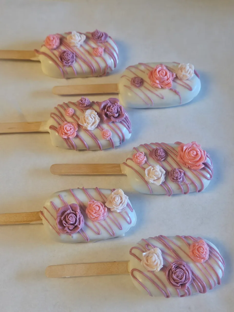 Collection of pink and white cake pops with ribbon details