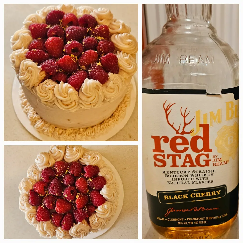 Round cake covered with fresh raspberries and piped chocolate frosting