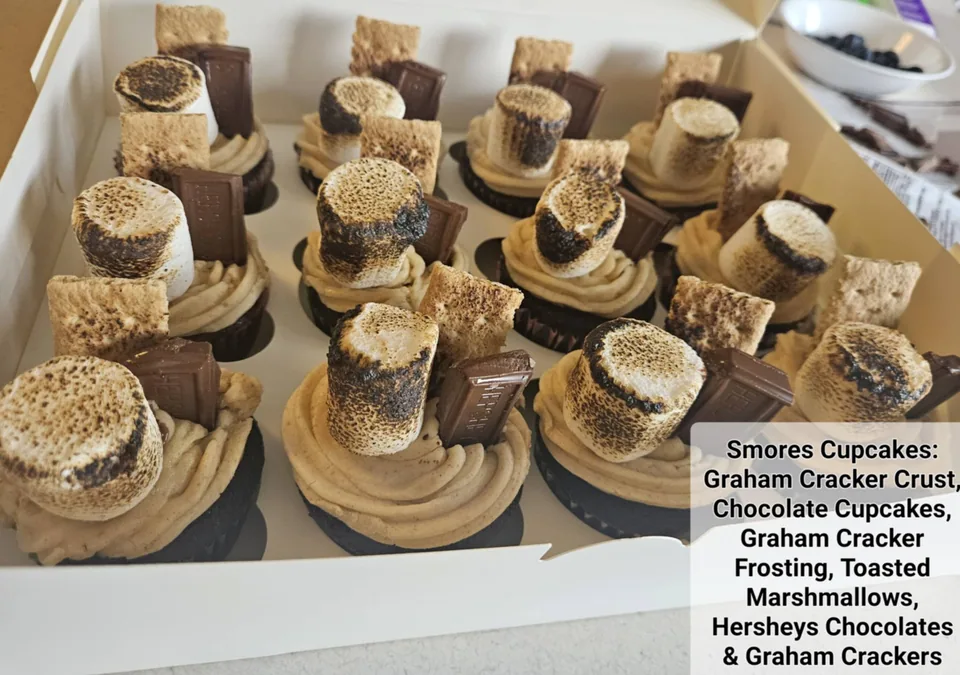 S'mores cupcakes with graham cracker crusts, chocolate cake, frosting, and marshmallows
