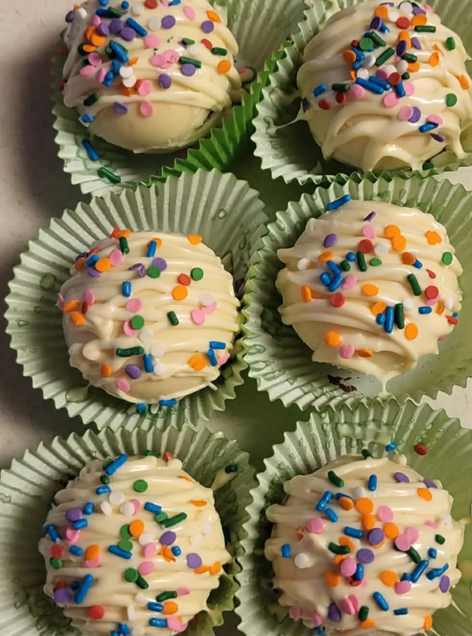 White chocolate confetti hot chocolate bombs with rainbow sprinkles